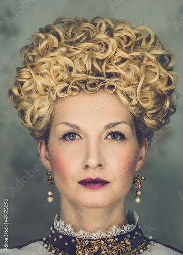 Photo: Portrait of beautiful haughty queen in royal dress Portrait of beautiful haughty queen in royal dress