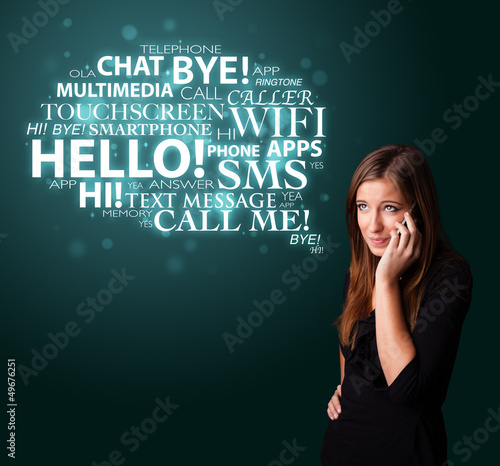 Photo: Young girl calling by phone with word cloud Young girl calling by phone with word cloud