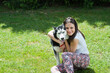 Photo: girl hugging her dog Siberian husky in yard girl hugging her dog Siberian husky in yard