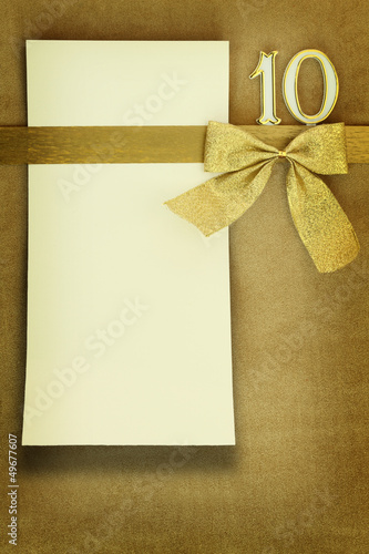 Photo: Anniversary card on golden background Anniversary card on golden background