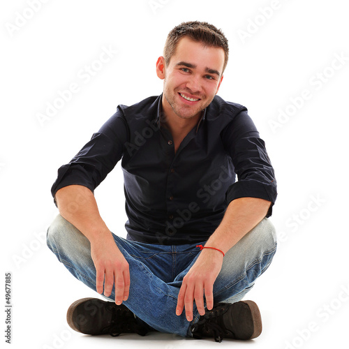 Photo: Young handsome guy sitting Young handsome guy sitting