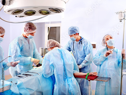 Photo: Surgeon at work in operating room. Surgeon at work in operating room.