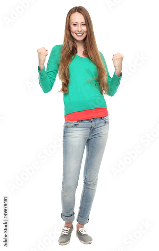Photo: Excited young woman clenching fists Excited young woman clenching fists