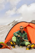The climber in tent against Mountains Altai