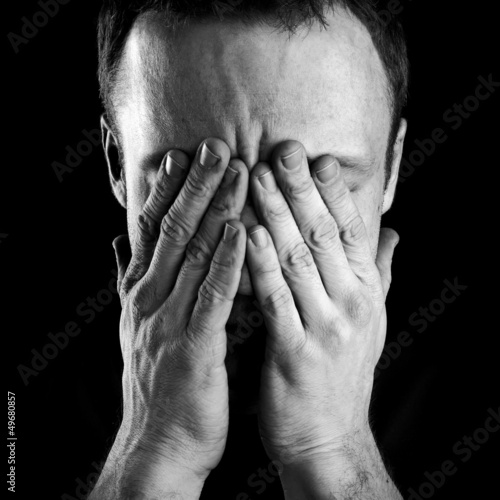 Photo: Portrait of stressed man covers his face with hands Portrait of stressed man covers his face with hands