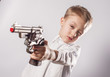 Kid holds the gun and aims