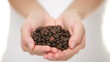 Coffee beans - woman showing coffee bean handful