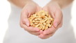 Cashew nuts - woman holding salty cashew nuts