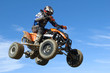 quad jumping on blue sky
