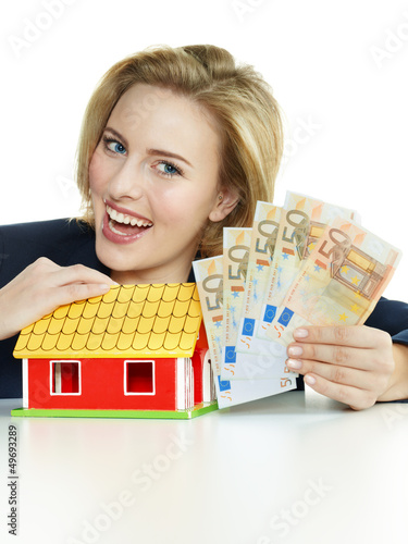 Photo: Business woman have enough money for building a house Business woman have enough money for building a house