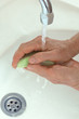 Woman washing hands with soap.