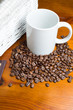 Photo: Coffee beans, cup and basket Coffee beans, cup and basket