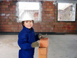 Happy little boy bricklayer
