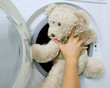 woman loading toy in the washing machine