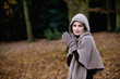 A woman rubbing her hands to keep warm in autumn time