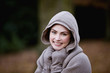 A woman wrapped up in warm clothes in autumn time