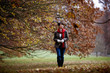 A woman walking through the countryside in autumn time