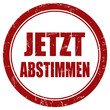 Grunge Stempel rot rund JETZT ABSTIMMEN