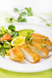fried, braded chicken fillet with fresh salad