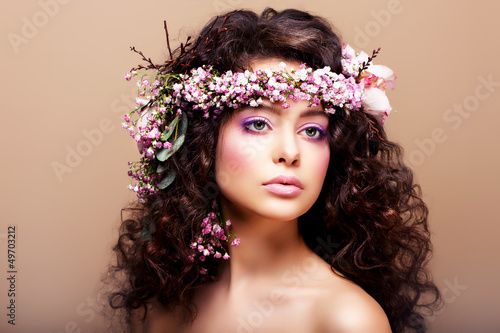 Photo: Luxuriant. Femininity. Fashion Model with Wreath of Flowers Luxuriant. Femininity. Fashion Model with Wreath of Flowers