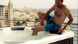 Young man getting into jacuzzi, slow motion shot at 120fps
