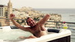 Young man getting into jacuzzi, slow motion shot at 240fps