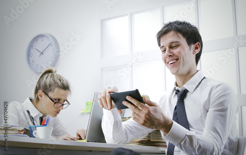 Photo: businessman using smart phone in office businessman using smart phone in office