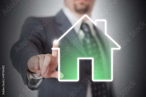 Photo: Businessman drawing an house with his finger Businessman drawing an house with his finger