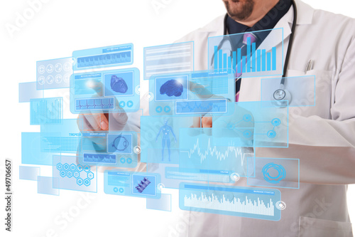 Photo: Male doctor working on a futuristic touchscreen display Male doctor working on a futuristic touchscreen display