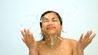 Happy woman splashing water on her face