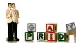 Gay groom cake toppers beside blocks  spelling gay pride