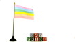 Rainbow flag blowing in the wind beside gay pride blocks