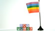 Rainbow flag blowing in the breeze beside gay pride blocks