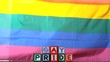 Rainbow flag blowing in the breeze with gay pride blocks