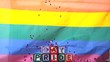Rainbow flag blowing in the breeze with gay pride blocks