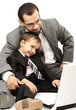 Portrait of a happy young man and his son working on laptop