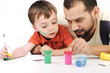 Photo: Father and kid playing with paint colors Father and kid playing with paint colors