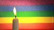 Candle against rainbow flag
