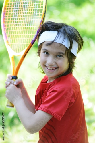 Photo: Kid playing tennis Kid playing tennis