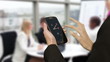 Businesswoman using smart phone in meeting