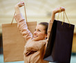 Young woman shopping and holding bags at the mall