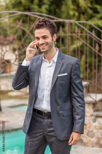 Photo: Young Businessman with Mobile Phone Young Businessman with Mobile Phone