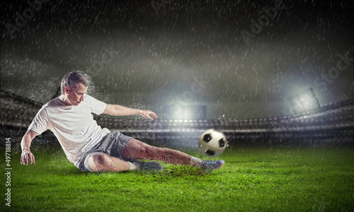 Photo: football player striking the ball football player striking the ball