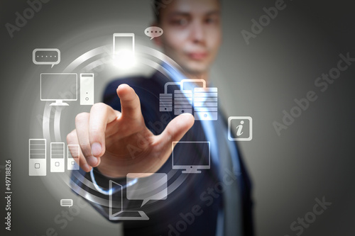 Photo: hand pushing on a touch screen hand pushing on a touch screen