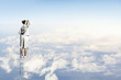 Businesswoman standing on ladder