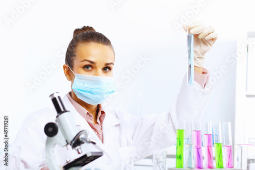 Photo: Young female scientist working in laboratory Young female scientist working in laboratory