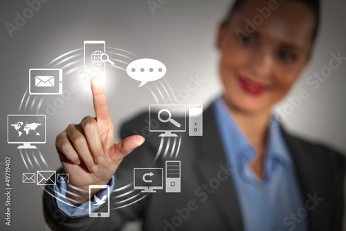 Photo: hand pushing on a touch screen hand pushing on a touch screen