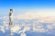 Businesswoman standing on ladder