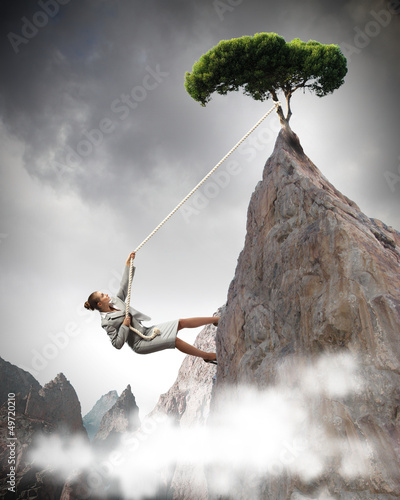 Photo: businesswoman climbing mountain businesswoman climbing mountain