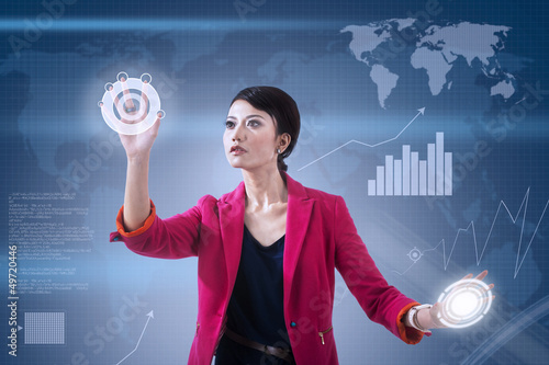 Photo: Businesswoman and global touchscreen Businesswoman and global touchscreen